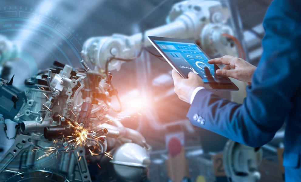 man in suit at machines with tablet