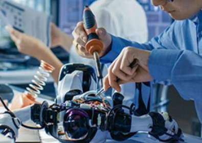 A person in a lab working on a machine.